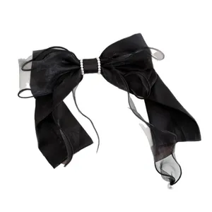 Elegant black satin and mesh bow hair clip with white pearl accents on white background