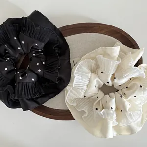 Set of large polka dot satin scrunchies with pleated edges in black and cream white