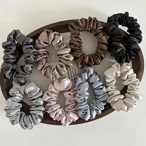 Set of 8 premium satin hair scrunchies in elegant colors displayed on a wooden tray