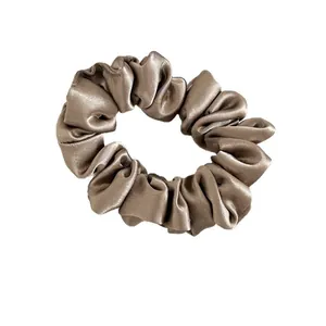 Elegant champagne satin pleated scrunchie with soft silk luster for ponytail styling