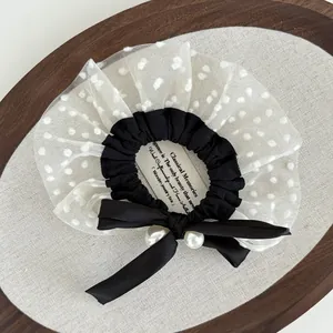 Detail of French vintage mesh hair tie with polka dots, silk bow and faux pearls