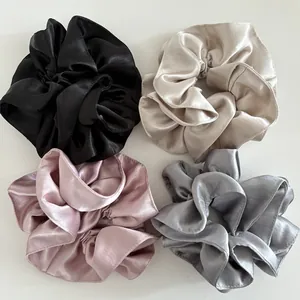 Set of four premium satin silk hair scrunchies in black, champagne, pink, and grey