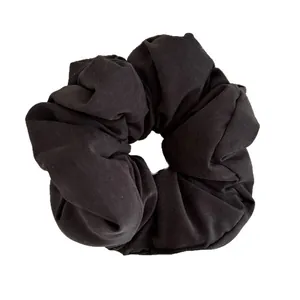 Minimalist puffy black scrunchie hair tie with soft matte fabric and pleated texture