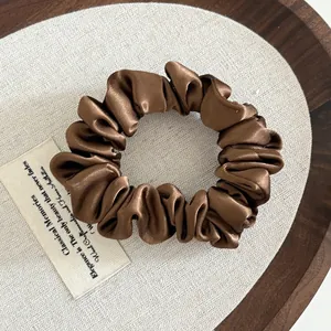 Brown satin scrunchie with pleated silk texture for ponytail hair ties styling