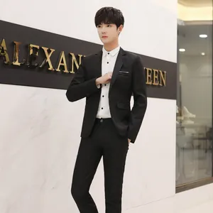 Detail of a slim-fit black business suit with a white shirt and matching trousers