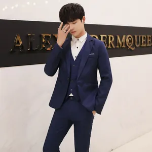 Detail of slim fit dark blue business suit with lapel, vest, and button accents