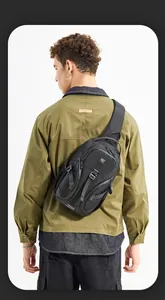 Rear view of model wearing black waterproof chest bag with multiple zip compartments