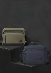 Close-up of durable navy and olive messenger bags with adjustable straps and front pockets