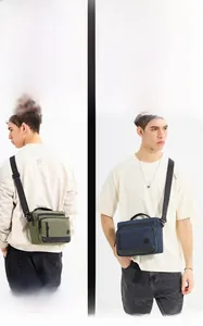 Detail of army green and navy blue men's messenger bags with multi-zipper compartments