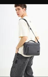 Detail view of large capacity nylon crossbody bag with leather bottom and adjustable strap