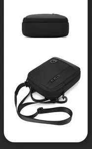 Detail view of black nylon shoulder bag with top handle and adjustable strap buckle