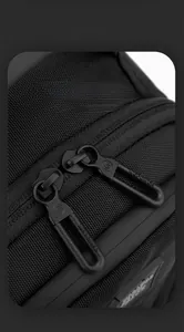 Detail of smooth double zippers and durable nylon fabric on this casual crossbody bag