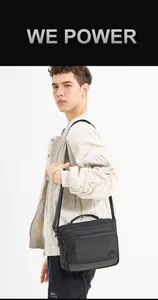 Macro shot of large black nylon crossbody bag with multi-pocket design and strap
