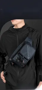 Detail view of the multi-layer zipper pockets on a water-resistant men's navy chest bag