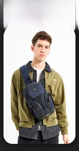 Detail of dark blue chest bag showing durable fabric, multi-zipper pockets and reflective strip