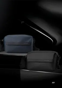Detail of lightweight navy and black crossbody bags with multi-compartment storage features