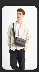 Detailed view of black nylon messenger bag with flap closure and adjustable strap