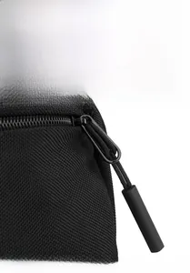Detail shot of smooth metal zipper and textured nylon fabric on the men's crossbody bag