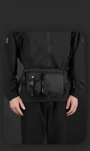Close-up of black water-resistant tactical chest bag with secure buckle and logo detail