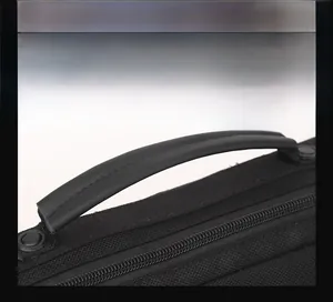 Close-up of reinforced handle and premium zipper on black high-density commuter bag