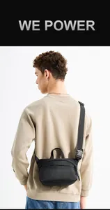 Rear view of minimalist black nylon crossbody chest bag worn by a male model
