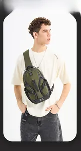 Detail of army green tactical sling bag with waterproof fabric and reflective strip