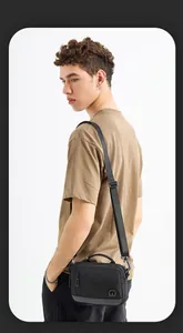 Detail of waterproof nylon crossbody bag featuring high-density fabric and logo print