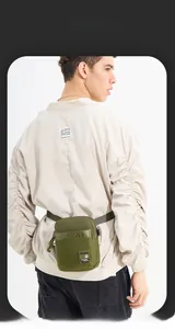 Detailed back view of olive green tactical waist bag with adjustable strap on a model