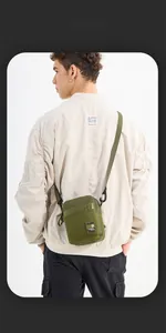 Detail of olive green tactical shoulder bag in wear-resistant oxford fabric with strap