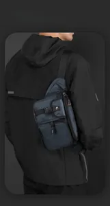 Detail of dark blue waterproof tactical chest bag with orange accents and buckle