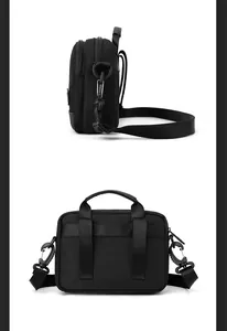 Detail view of black nylon shoulder bag showing double zippers and rear belt loop straps