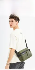 Detail of army green canvas crossbody bag with WEPOWER logo and adjustable strap