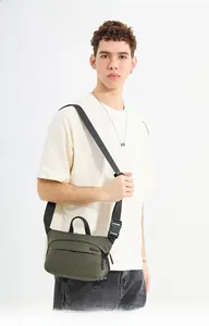 Men's army green crossbody bag showing side view fit and durable nylon material texture