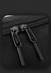 Gros plan détaillé sur le tissu en nylon et la fermeture éclair de ce sac noir pour homme