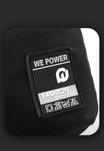 Detail of durable nylon fabric with silicone logo and washing instruction labels on crossbody bag
