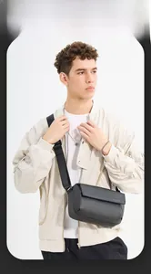 Man wearing a minimalist black waterproof crossbody bag with an adjustable wide strap