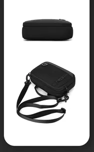 Macro detail of high-density black nylon cross body bag showing fabric texture and zippers