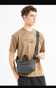 Close-up of a minimalist waterproof shoulder bag with adjustable strap and logo detail