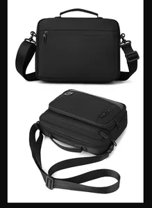 Rear and top view of black crossbody bag showing wide strap and durable nylon fabric