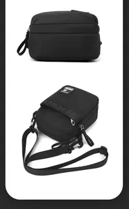 Detail of lightweight black crossbody bag with multiple zipper compartments and adjustable strap