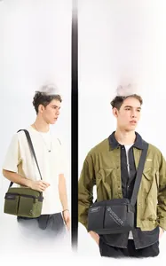 Detail view of large capacity nylon shoulder bags in olive green and black finishes