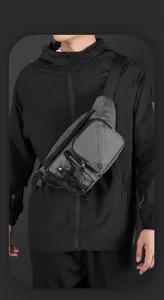 Detail of gray water-resistant men chest bag with multiple zip pockets and adjustable strap