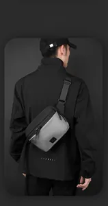 Detailed side view of a two-tone crossbody sling bag showing smart storage design