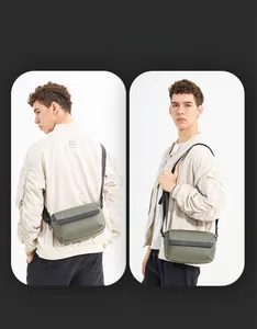 Detail view of military green crossbody bag showing smart storage and adjustable strap
