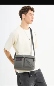 Detailed view of the dark grey waterproof nylon messenger bag with adjustable shoulder strap