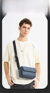 Detail of navy blue messenger bag with adjustable shoulder strap and buckle for men