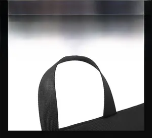 Macro shot of durable black nylon webbing handle on minimalist men's crossbody bag