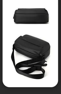 Detail view of black waterproof matte crossbody bag with adjustable strap and WE POWER logo