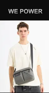 Close-up of grey nylon crossbody bag with textured fabric and dual zipper pockets