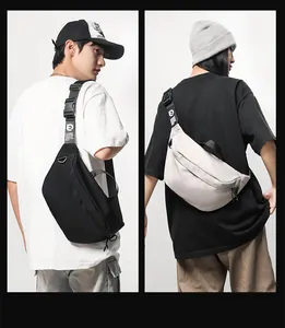 Detail view of large capacity crossbody bags in black and beige with adjustable straps